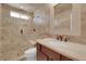 Stylish bathroom with tiled shower, pebble floor, and vanity sink at 9906 Stiges St, Las Vegas, NV 89178