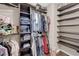 Walk-in closet featuring built-in shelving and hanging rods for organized storage at 9906 Stiges St, Las Vegas, NV 89178