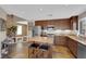 Well-equipped kitchen boasts stainless steel appliances, sleek granite counters, custom cabinetry, and an island with seating at 9906 Stiges St, Las Vegas, NV 89178