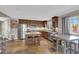 Gourmet kitchen featuring stainless steel appliances, dark wood cabinetry, granite countertops, and a center island with bar seating at 9906 Stiges St, Las Vegas, NV 89178