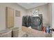 Laundry room with neutral paint, cabinetry, and modern washer and dryer at 9906 Stiges St, Las Vegas, NV 89178
