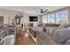 Comfortable living room area with large sectional sofa, hardwood floors, and bright windows at 9906 Stiges St, Las Vegas, NV 89178