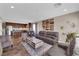 Open concept living room with tile floors and adjacent kitchen with stainless steel appliances at 9906 Stiges St, Las Vegas, NV 89178