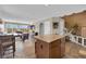 Inviting open-concept living area with tile floors, a cozy living room, dining space, and direct access to the kitchen at 9906 Stiges St, Las Vegas, NV 89178