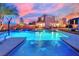 Stunning backyard pool with vibrant blue lighting and a fun basketball hoop at 9906 Stiges St, Las Vegas, NV 89178