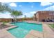 Backyard pool features beautiful landscaping and seating area with trees at 9906 Stiges St, Las Vegas, NV 89178