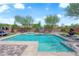 Backyard pool and lounge area featuring a water feature and basketball hoop at 9906 Stiges St, Las Vegas, NV 89178
