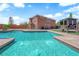 Backyard pool, sunbathing lounge, and manicured lawn create a luxurious outdoor oasis at 9906 Stiges St, Las Vegas, NV 89178