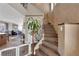 Staircase with stylish tile flooring and an wrought iron railing leading to the upper level at 9906 Stiges St, Las Vegas, NV 89178