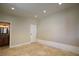 Neutral bedroom features tile floors, a white door and access to an ensuite bathroom at 1006 Bel Air Cir, Las Vegas, NV 89109