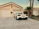 Charming home featuring a private driveway leading to garages with palm trees along the side at 1006 Bel Air Cir, Las Vegas, NV 89109
