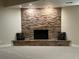 Living area featuring a stacked stone fireplace, neutral walls, and comfortable seating at 1006 Bel Air Cir, Las Vegas, NV 89109