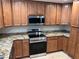 Kitchen featuring granite counters, stainless steel appliances, and wood cabinets at 1006 Bel Air Cir, Las Vegas, NV 89109