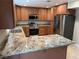 Well-lit kitchen featuring granite counters, wood cabinets, and stainless steel appliances at 1006 Bel Air Cir, Las Vegas, NV 89109