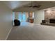 Cozy living room featuring a stone fireplace, plush carpeting, and access to the outdoors at 1006 Bel Air Cir, Las Vegas, NV 89109