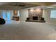 Spacious living room boasts a stone fireplace, plush carpeting, and an open layout to the kitchen at 1006 Bel Air Cir, Las Vegas, NV 89109