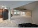 Expansive living room with stone fireplace, plush carpeting, and open access to the kitchen at 1006 Bel Air Cir, Las Vegas, NV 89109