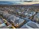 Dusk aerial view capturing the neatly arranged community with backyard lights and mountain backdrop at 10140 Magnolia Creek St, Las Vegas, NV 89141