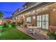 Enjoy the covered patio with string lights, artificial turf, and stylish brickwork in this lovely backyard at 10140 Magnolia Creek St, Las Vegas, NV 89141