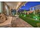 Covered backyard patio with string lights and an outdoor seating area perfect for entertaining at 10140 Magnolia Creek St, Las Vegas, NV 89141