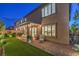 Inviting backyard with covered patio, string lights, artificial turf, and attractive brickwork at 10140 Magnolia Creek St, Las Vegas, NV 89141
