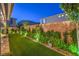Lush backyard featuring manicured greenery, privacy fencing, and decorative elements at 10140 Magnolia Creek St, Las Vegas, NV 89141