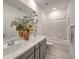 Bathroom featuring double sinks, gray cabinets, and a separate shower-tub combination at 10140 Magnolia Creek St, Las Vegas, NV 89141