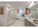 Bathroom with glass enclosed shower and soaking tub with double sink vanity at 10140 Magnolia Creek St, Las Vegas, NV 89141
