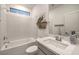 Bright bathroom featuring a bathtub, toilet, and a vanity with a white countertop and sink at 10140 Magnolia Creek St, Las Vegas, NV 89141
