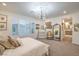 Bedroom featuring a queen bed, chandelier and access to ensuite bathroom at 10140 Magnolia Creek St, Las Vegas, NV 89141