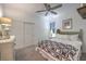 Cozy bedroom with a ceiling fan, queen bed with patterned quilt, and classic white dresser at 10140 Magnolia Creek St, Las Vegas, NV 89141