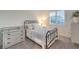 A well-lit bedroom featuring a vintage style bed, dresser, carpet, and a shuttered window at 10140 Magnolia Creek St, Las Vegas, NV 89141