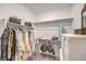 Bright walk-in closet with ample storage featuring rods, shelves, and visible decor items at 10140 Magnolia Creek St, Las Vegas, NV 89141
