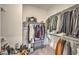 Walk-in closet with metal racks and shelves providing ample storage for clothes, bags, and shoes at 10140 Magnolia Creek St, Las Vegas, NV 89141
