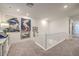 Upstairs hallway with neutral carpet, leading to rooms with white molding and ample lighting at 10140 Magnolia Creek St, Las Vegas, NV 89141