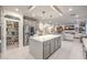 Open-concept kitchen with an island, stainless appliances, pantry, and view into the living room at 10140 Magnolia Creek St, Las Vegas, NV 89141