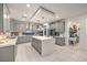 Spacious kitchen featuring a large center island, stainless steel appliances, and elegant gray cabinetry at 10140 Magnolia Creek St, Las Vegas, NV 89141