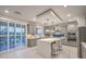 Modern kitchen with gray cabinets, a kitchen island, stainless steel appliances, and tile flooring at 10140 Magnolia Creek St, Las Vegas, NV 89141