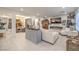 Inviting living room with a fireplace, white sofa, and vintage decor throughout the open space at 10140 Magnolia Creek St, Las Vegas, NV 89141