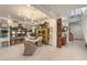 Bright, stylish living area with vintage decor, an ornate chandelier, and access to the stairway at 10140 Magnolia Creek St, Las Vegas, NV 89141