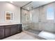 Modern bathroom featuring a glass enclosed shower with tiled walls and a sleek vanity with a lighted mirror at 1021 Golden Summit Dr, Las Vegas, NV 89138