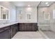 Contemporary bathroom with double vanity, illuminated mirrors, and a spacious glass-enclosed shower at 1021 Golden Summit Dr, Las Vegas, NV 89138