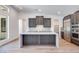 Modern kitchen showcasing a quartz island, stainless steel appliances, and dark wood cabinets at 1021 Golden Summit Dr, Las Vegas, NV 89138
