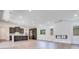 Inviting living space with light wood floors, recessed lighting, a fireplace, and seamless kitchen access at 1021 Golden Summit Dr, Las Vegas, NV 89138