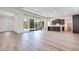Open floor plan featuring light wood floors, large windows, and seamless flow to the kitchen at 1021 Golden Summit Dr, Las Vegas, NV 89138