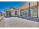 Spacious brick patio with covered area, large windows and sliding doors, perfect for outdoor entertaining at 1021 Golden Summit Dr, Las Vegas, NV 89138