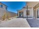 Paver patio and stucco home exterior with sliding glass doors providing backyard access at 1021 Golden Summit Dr, Las Vegas, NV 89138
