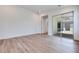 Large room features hardwood flooring, neutral walls, and sliding glass doors to the outdoors at 1021 Golden Summit Dr, Las Vegas, NV 89138