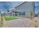Landscaped backyard with artificial grass, pavers, desert landscaping, and a covered patio at 10448 Smokey Mariposa, Las Vegas, NV 89166