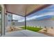 Backyard features concrete slab, gravel landscaping, artificial turf, and a covered patio at 10448 Smokey Mariposa, Las Vegas, NV 89166